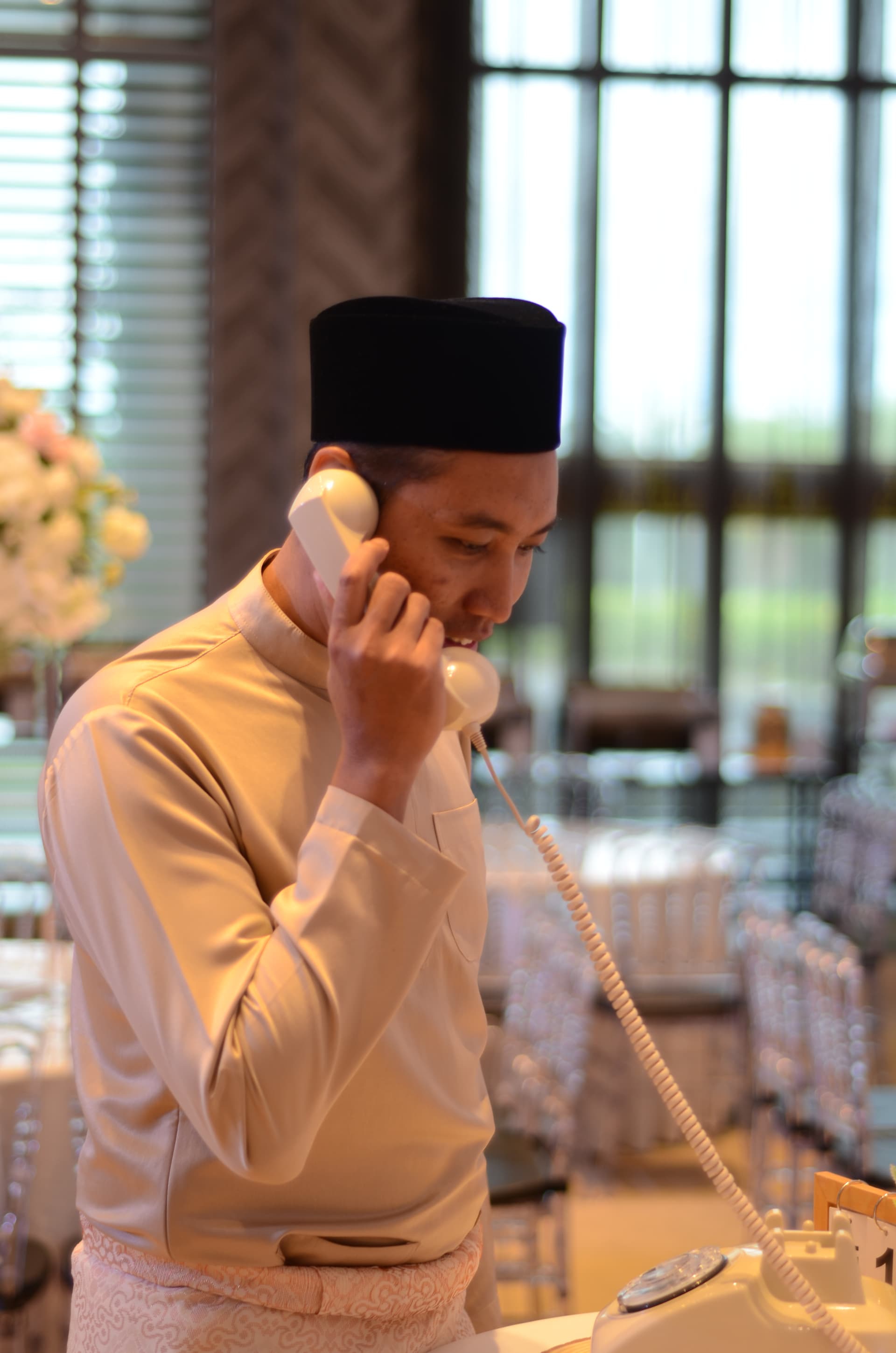 A wedding guest smiling as he records a message on an Enchanttone guestbook