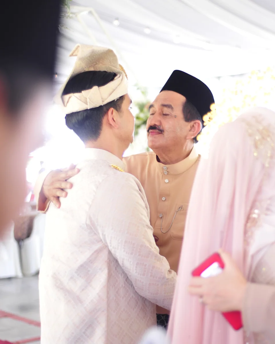 The groom sharing a quiet moment with an elder guest